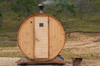Original wooden bath in the form of a barrel. Mobile compact bathhouse on the shore of Sarai beach, Olkhon island Russia