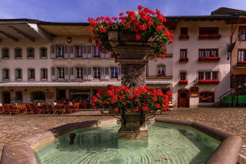 Wall Mural - Fountain in Gruyere village in Fribourg canton by beautiful day, Switzerland