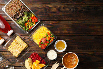 Food delivery. Food in takeaway boxes on wooden table