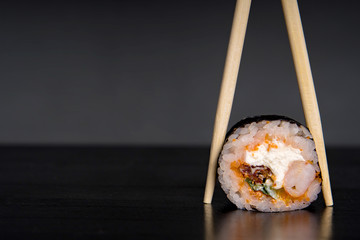 Wall Mural - sushi and sushi sticks on a dark background