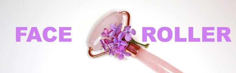 Pink quartz face roller massager for skin treatment on whit background. Home spa settings. Derma rollerю