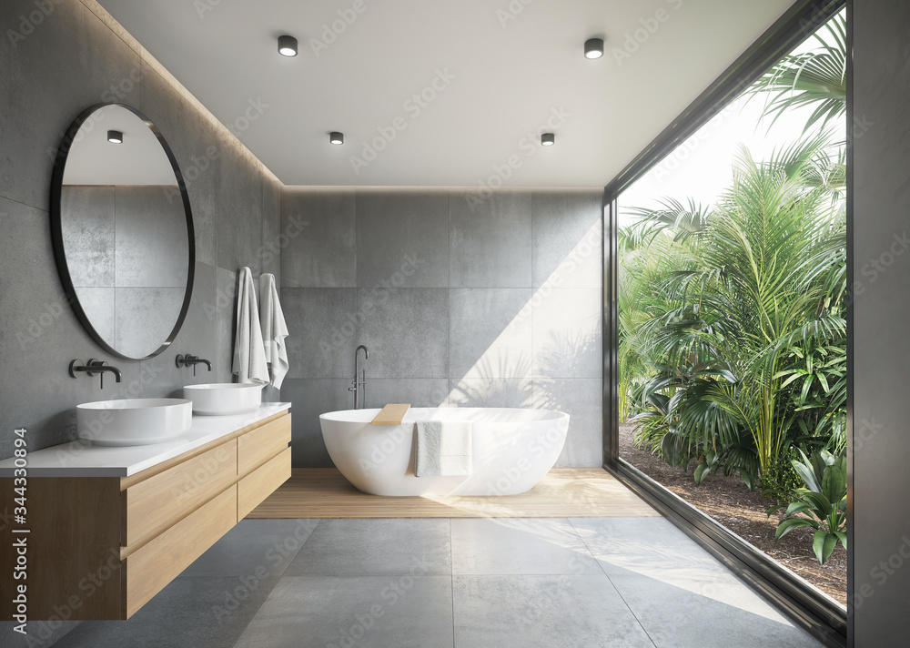 Grey concrete tiled bathroom with opening to a jungle garden a round mirror and a bathtub - obrazy, fototapety, plakaty 