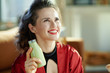 © Alliance - smiling woman with bottle of smoothie looking up on copy space