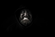 Portrait Of Angry Man Against Black Background