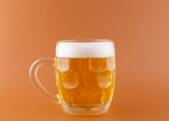 Mug of beer isolated on colored background, still-life photography