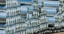 Large Silver Pipes Stacked At Factory