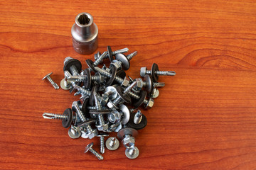 Photos bolts, nuts, screws on the wooden background