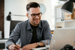 © JustLife - Businessman in office. Handsome man working on lap top.