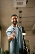 © JustLife - Businessman giving a handshake in office. Handsome man at work.