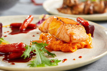 Wall Mural - Salmon fillet with beet in herbs and passion fruit sauce close up