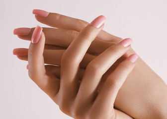 Beautiful Woman Hands. Soft skin, spa skincare concept. Female Hands Applying Cream or Lotion. Hands with pink manicure