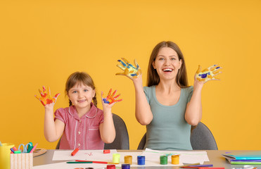 Wall Mural - Drawing teacher giving private art lessons to little girl on color background