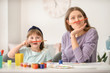 © Pixel-Shot - Drawing teacher and little girl having fun during private art lessons at home