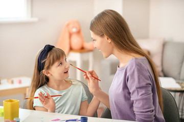 Sticker - Drawing teacher giving private art lessons to little girl at home