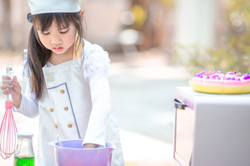 Close up background view Of cute young girls cooking desserts, with an oven and flour, cooking business concepts,learning models and marketing plans