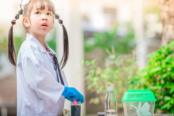 Close-up background view of a cute girl Who are learning science, business concepts, experimenting with chemical coloring or marketing planning