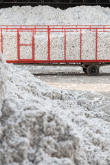 Wall Mural - Tractor and trolley passing through the seed cotton piles in a ginning mill in Greece