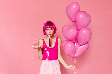 Poster - Image of woman blowing in party horn while holding balloons and cake