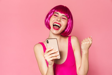 Poster - Image of young happy girl wearing wig smiling and holding cellphone