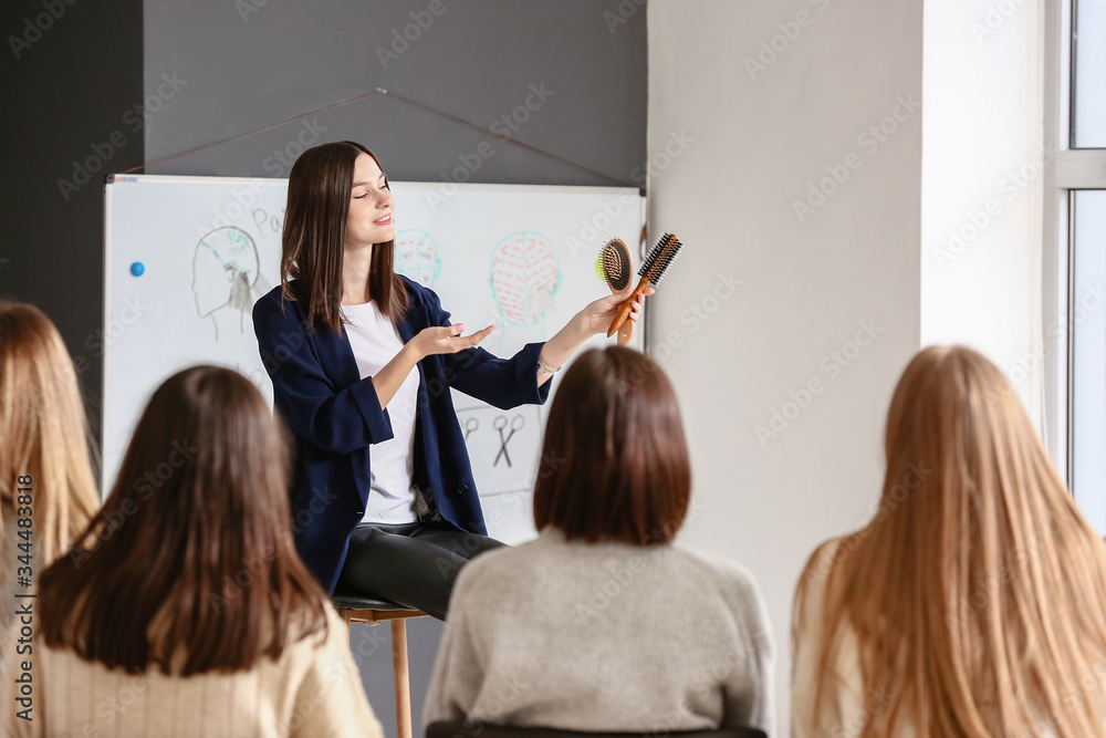 Professional hairdresser teaching young people in office