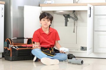 Poster - Portrait of little plumber in kitchen