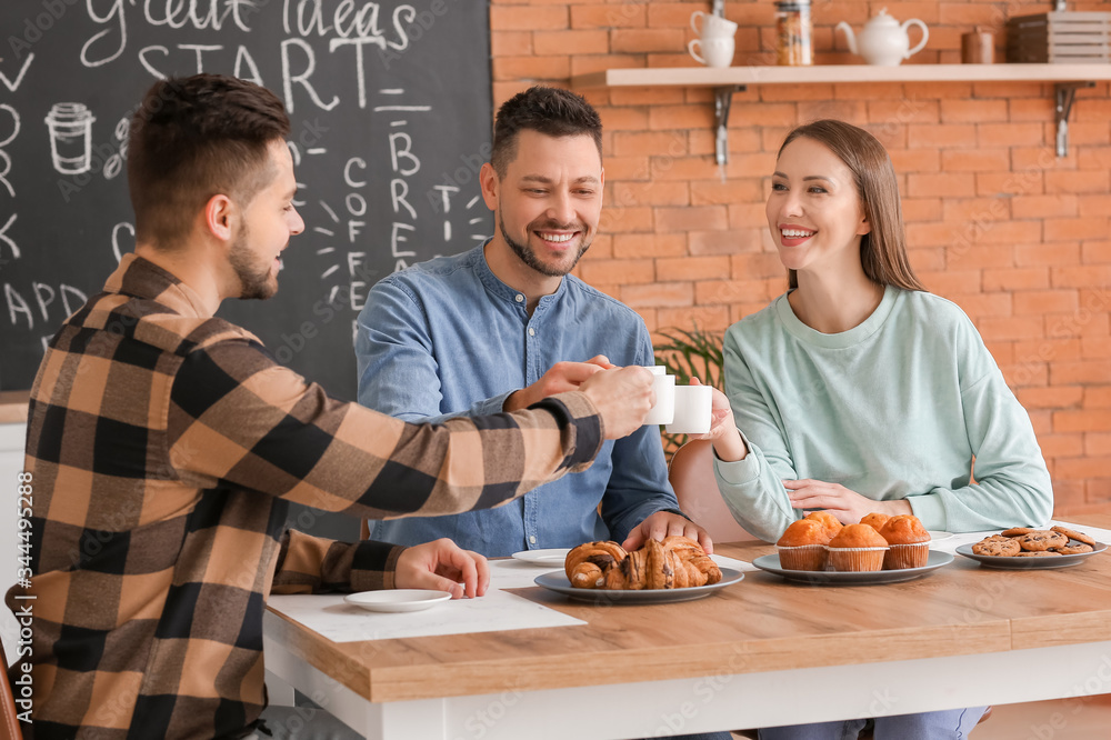 Colleagues drinking coffee in kitchen of office
