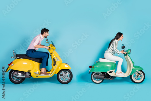 Full body profile side photo of energetic bikers drive yellow green choppers drive fast compete on road route wear white formalwear shirt pants trousers isolated over blue color background