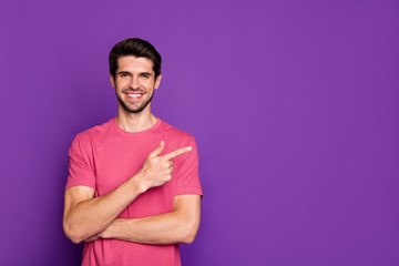 Wall Mural - Portrait of positive cheerful guy promoter point index finger copyspace present ads promo sales wear good look clothes isolated over shine color background