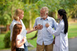 © phonix_a - Female doctor and her elderly patient family outdoor.