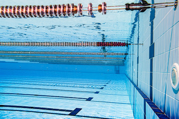 Wall Mural - Olympic Swimming pool under water background.