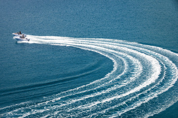 two speedboat runs fast in the open sea and leaves the engine's wake in the water