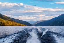 The Wake Of The Stern Of A Motor Boat Sailing On A Mountain Lake. Fall. Russia, Altai Republic, Lake Teletskoye