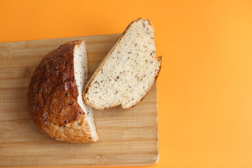 fresh bread with flax cut on a wooden Board