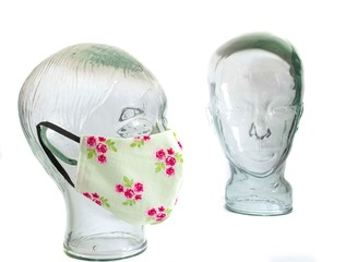 PPE personal protective equipment   face masks  on faceless  glass heads   white back ground 