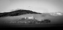 Alcatraz Island In Sea Against Mountain In Foggy Weather