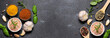© Iryna - Long wide banner with different spices and herb on black stone background with copy space for your text. Template food blog social media.