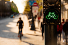 Sustainable Transport. Bicycle Traffic Signal, Green Light, Road Bike, Free Bike Zone Or Area, Bike Sharing With Silhouette Of Cyclist And Bike On The Blurred Background, Bike-friendly