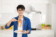 © Jedsada - Asian man showing  freash salmon steak fillet, happy and surprise face in white kitchen.