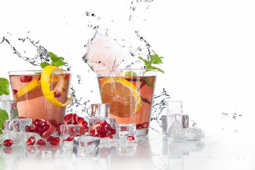 Wall Mural - summer pomegranate drink with lemon and mint with splashed water and ice