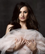 © Dmitry Lobanov - Portrait of young beautiful brunette woman in light pink sleeveless vintage dress with unusual decoration and earrings