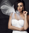 © Dmitry Lobanov - Portrait of young beautiful brunette woman in white vintage dress with unusual decoration and earrings