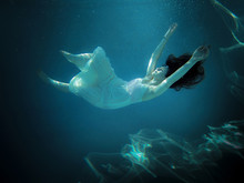 Side View Of A Young Woman Underwater