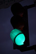 Green traffic light against the sky at twilight. Green light is on at a traffic light pole in the evening.
