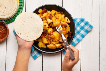 Mexican potatoes with chorizo on white background