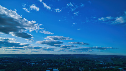 Wall Mural - Blue sky and multiple clouds background showing a horizon