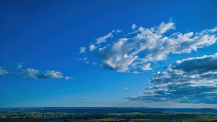Wall Mural - Blue sky and multiple clouds background showing a horizon