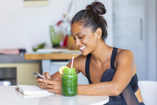 Latin Woman Staying Healthy At Home Having A Green Juice