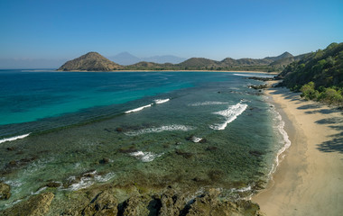 Wall Mural - Pristine beach scene with no people or houses and Rinjani volcano in distance shot in Sumbawa Island, NTB, Indonesia