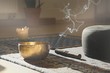 © ummanandapics - meditation room with singing bowl, incense stick, smoke, pillow and candle