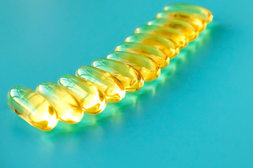 Wall Mural - handful of omega 3 capsules on a blue background